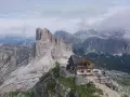 Rifugio alpino incastonato tra le vette maestose delle Dolomiti Bellunesi, un'oasi di pace e avventura.