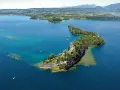 Le splendide isole del Lago di Garda, con ville storiche e vegetazione lussureggiante, emergono dalle acque turchesi.