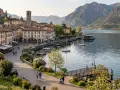 Pisogne: cosa vedere sul lago d'Iseo. Borgo con campanile, case colorate, lungolago con barche e montagne sullo sfondo.