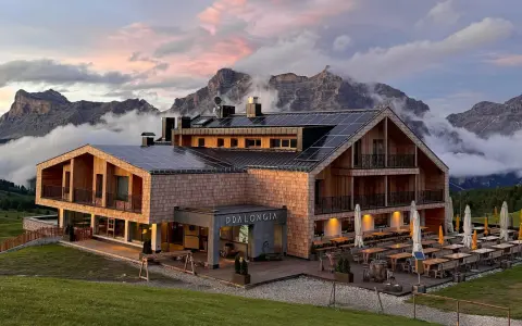 Rifugio Pradlongia, con pannelli solari e vista sulle montagne, è raggiungibile con un sentiero panoramico.