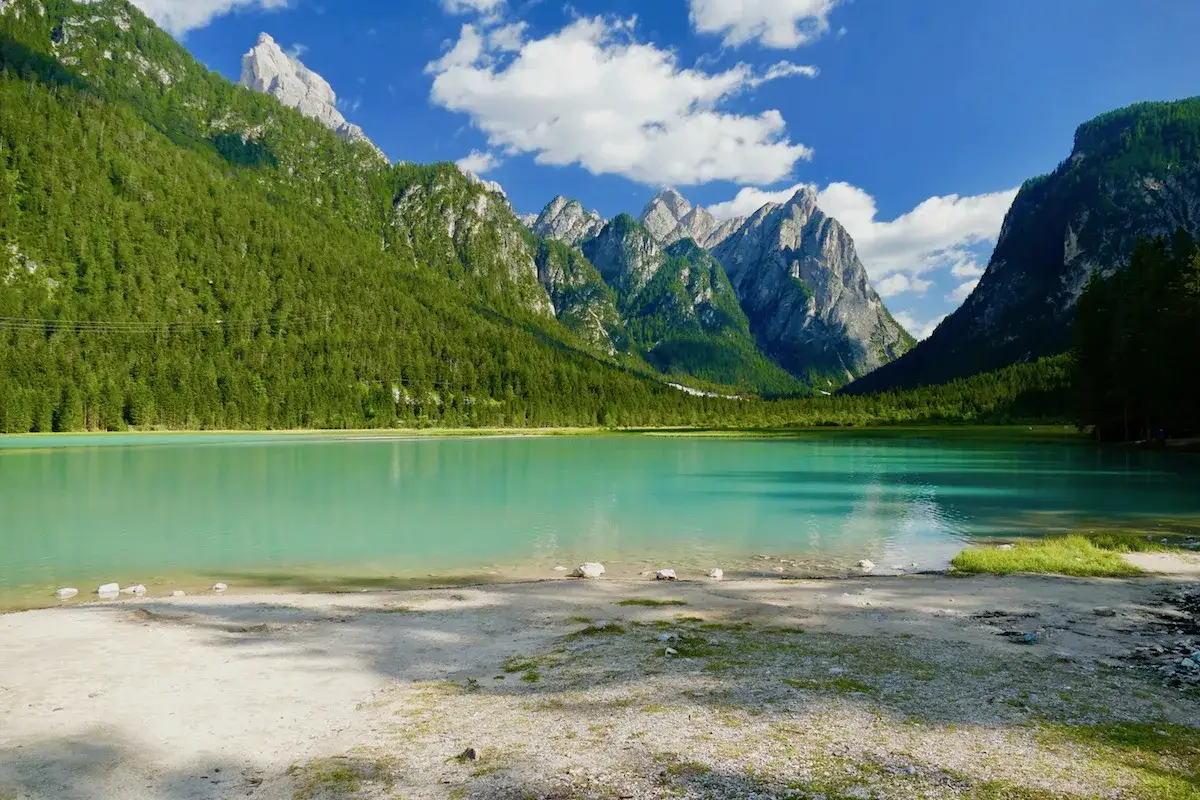 Splendido lago turchese circondato da montagne verdi e rocciose. Ideale per una toblacher see wanderung.